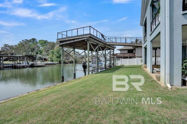 dock area with a yard and a water view