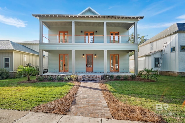 view of front facade with a front yard, a porch, and a balcony