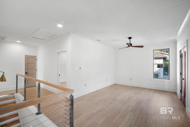 spare room featuring light hardwood / wood-style floors, crown molding, and ceiling fan