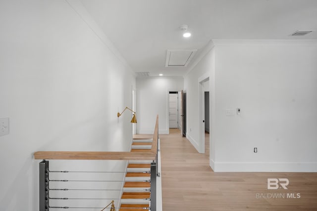 stairway with crown molding and wood-type flooring