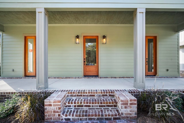 view of exterior entry with a porch