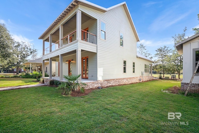 view of home's exterior featuring a yard and a balcony