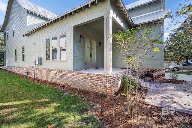 view of property exterior featuring a yard and a patio