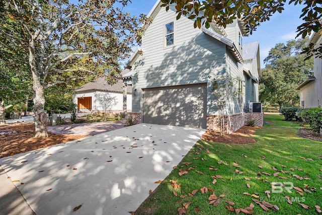 view of property exterior featuring cooling unit, a yard, and a garage