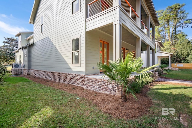 view of side of home featuring a lawn