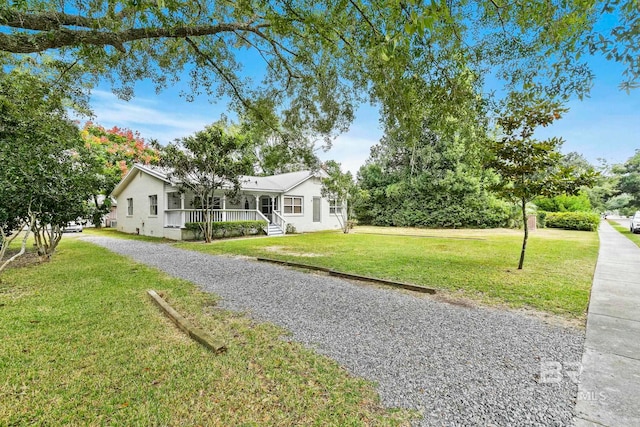 ranch-style house with a front yard and a porch