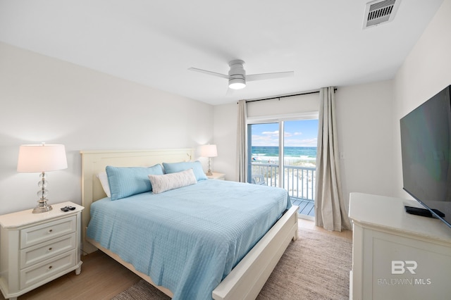 bedroom featuring light wood-type flooring, access to exterior, visible vents, and a ceiling fan