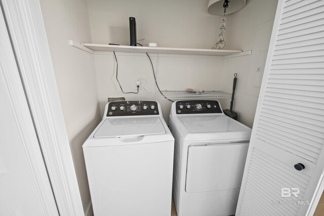 clothes washing area with laundry area and washer and clothes dryer