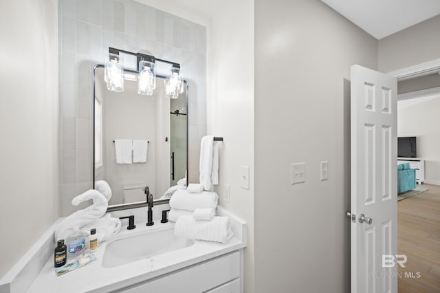 full bath featuring wood finished floors and vanity