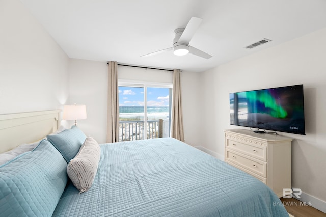 bedroom featuring baseboards, visible vents, a ceiling fan, wood finished floors, and access to exterior