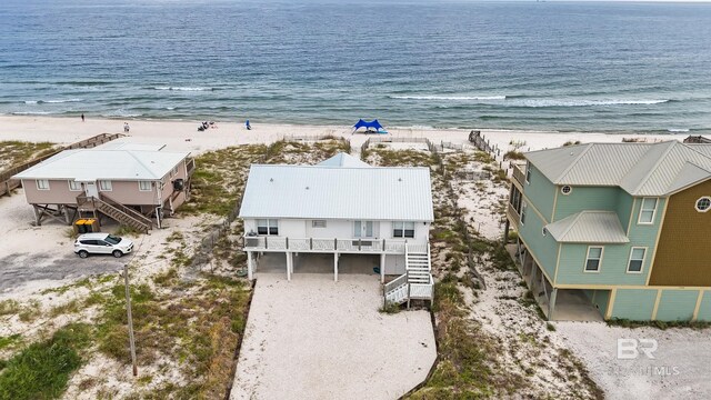 birds eye view of property featuring a view of the beach and a water view