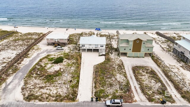 aerial view featuring a water view and a view of the beach