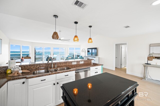 kitchen with a sink, visible vents, white cabinetry, light wood-style floors, and stainless steel dishwasher