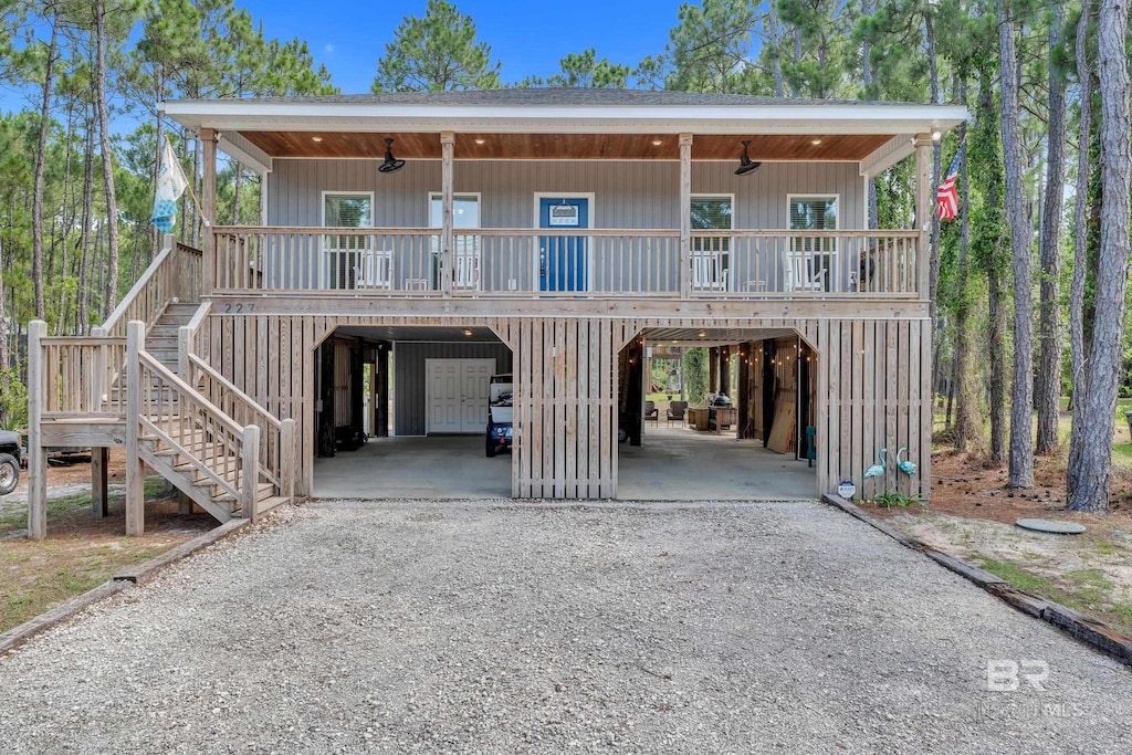 227 Conde Ave, Dauphin Island, AL 36528 - view of front of home with a carport, ceiling fan, stairs, and a porch