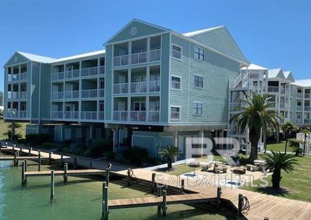 view of property's community featuring a boat dock and a water view