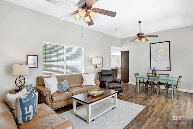 living room with ceiling fan and light hardwood / wood-style flooring