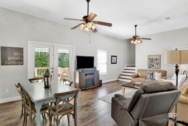 living room with ceiling fan and dark hardwood / wood-style flooring