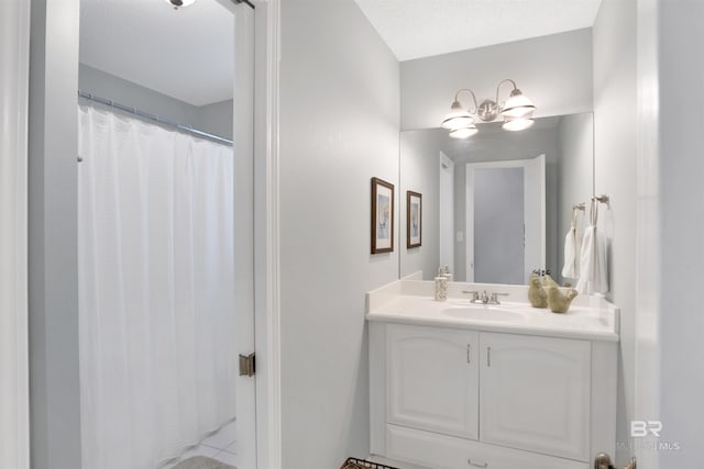 bathroom featuring a notable chandelier and vanity