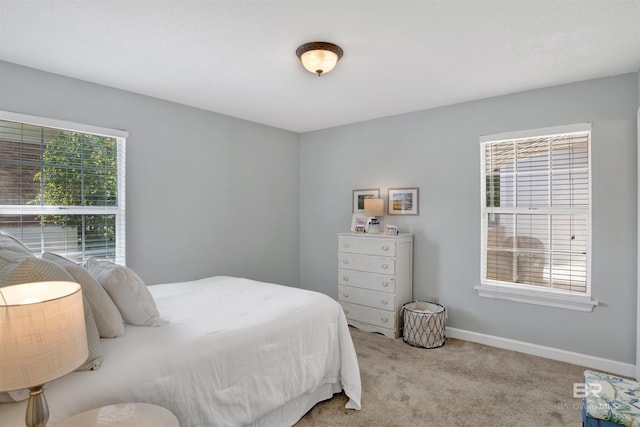 bedroom featuring light carpet