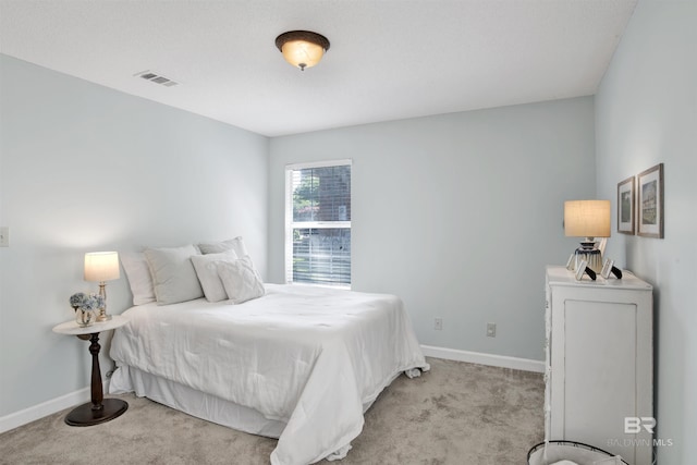 bedroom featuring light carpet