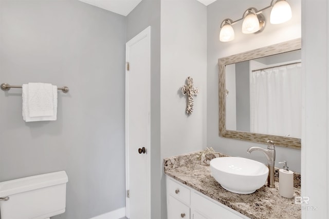 bathroom featuring vanity and toilet