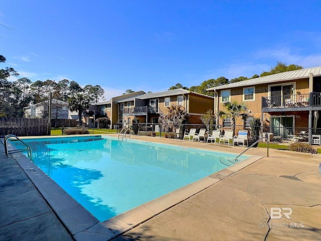 pool with a residential view and fence