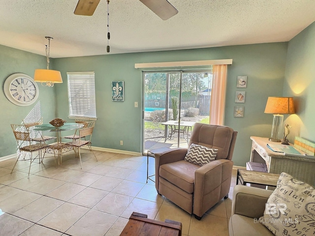 interior space with a healthy amount of sunlight, light tile patterned floors, a ceiling fan, and a textured ceiling