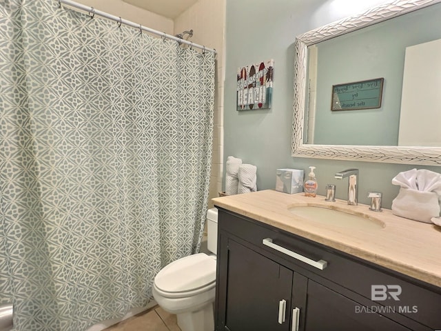 bathroom with tile patterned flooring, vanity, and toilet