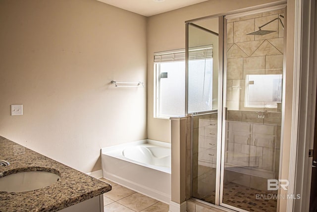 full bathroom with double vanity, a bath, tile patterned floors, a shower stall, and a sink