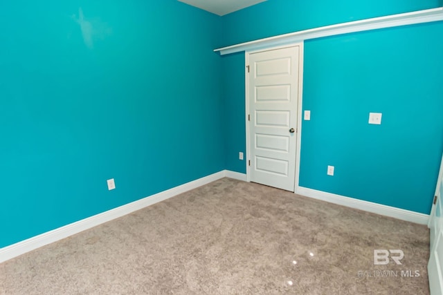 spare room with carpet flooring and baseboards