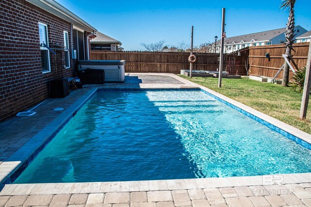 view of pool with a patio area, a fenced backyard, a lawn, and a hot tub