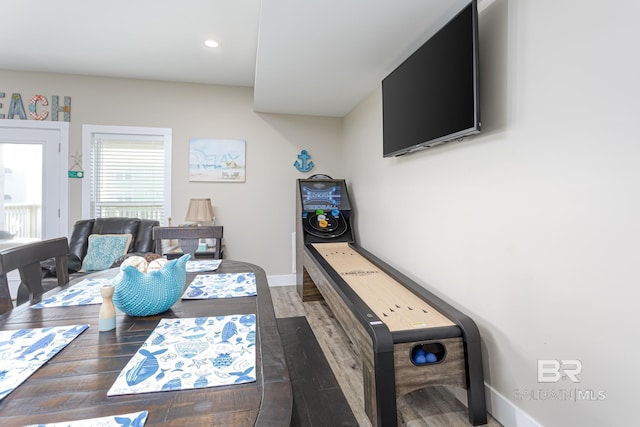 dining area featuring baseboards, wood finished floors, and recessed lighting