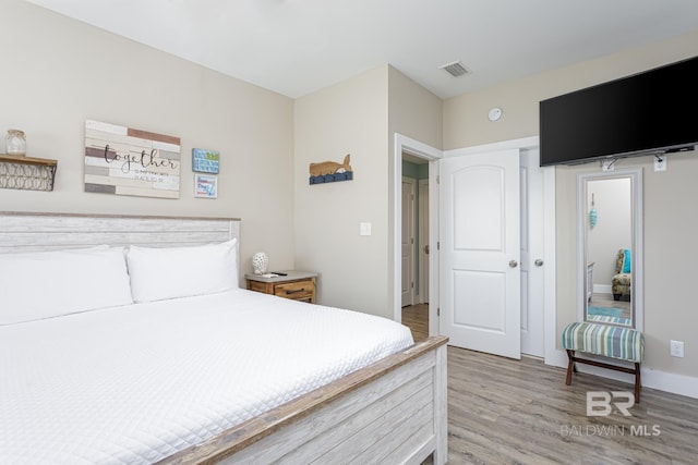 bedroom with visible vents and light wood finished floors