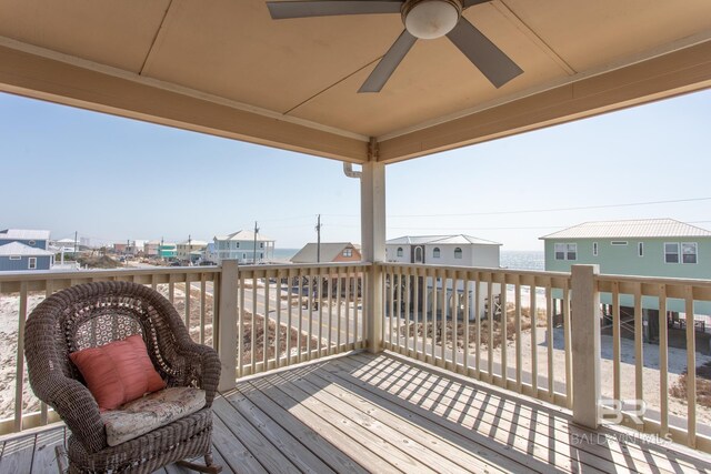 deck featuring a ceiling fan and a residential view