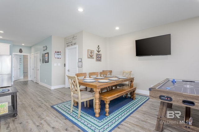 dining space featuring baseboards, recessed lighting, and light wood-type flooring