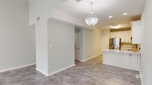 kitchen with visible vents, light countertops, white cabinetry, a sink, and appliances with stainless steel finishes
