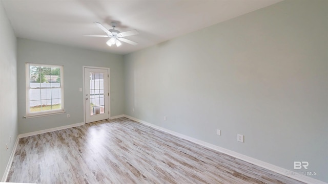unfurnished room with baseboards, ceiling fan, and light wood finished floors