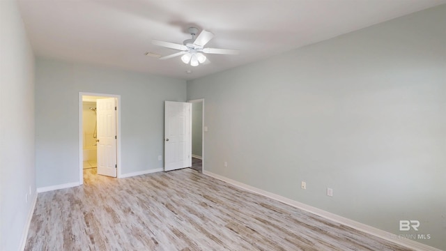 empty room with baseboards, ceiling fan, and light wood-style floors