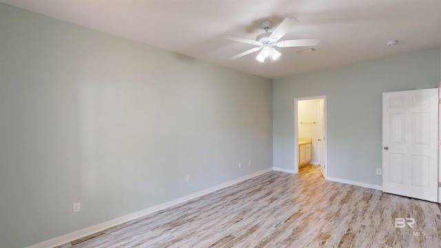 spare room with light wood-style floors, baseboards, ceiling fan, and visible vents