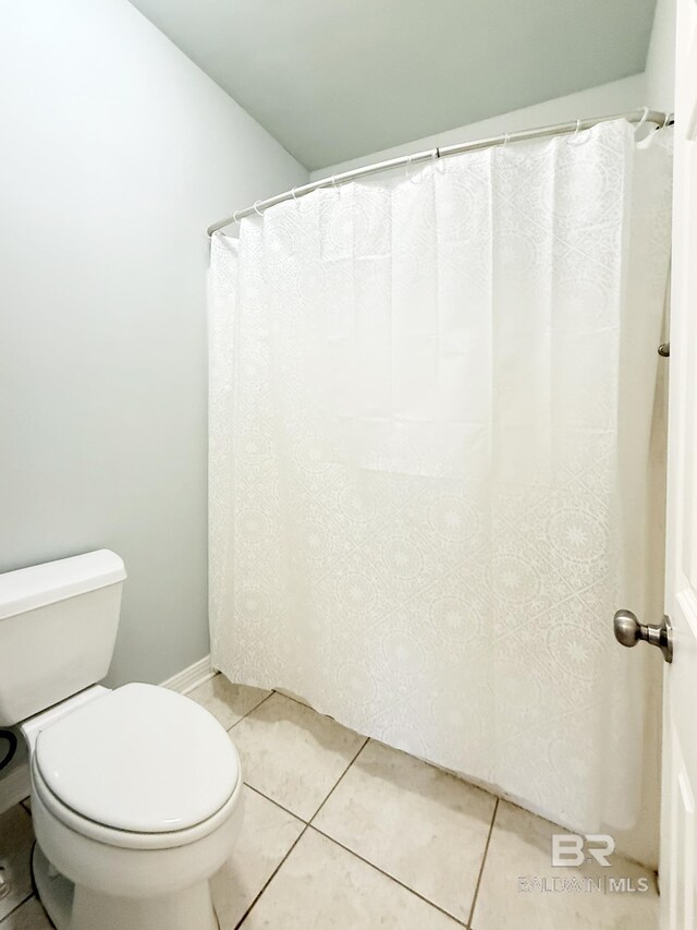 full bathroom with toilet, baseboards, and tile patterned flooring