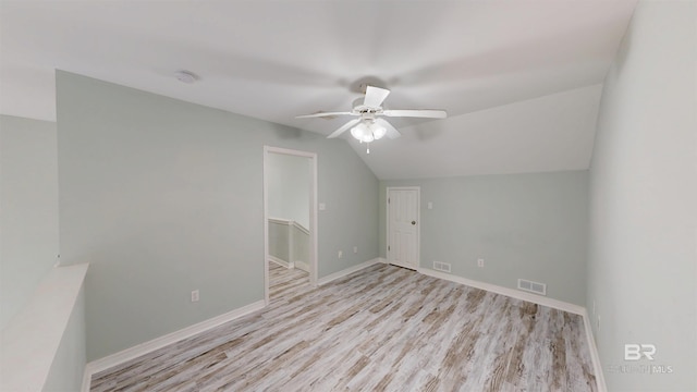 interior space with visible vents, a ceiling fan, wood finished floors, and vaulted ceiling