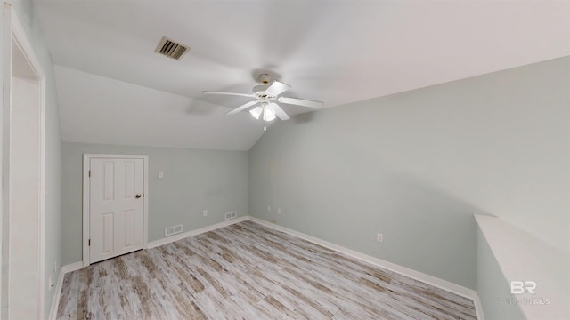 additional living space with ceiling fan, lofted ceiling, light wood finished floors, and visible vents