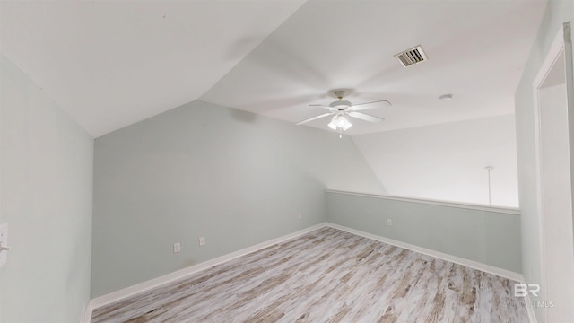 bonus room with ceiling fan, vaulted ceiling, light wood finished floors, and visible vents