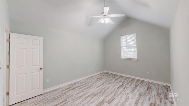 additional living space with baseboards, ceiling fan, wood finished floors, and vaulted ceiling