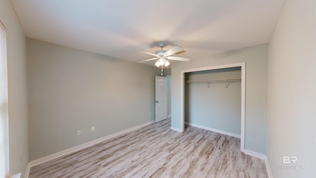 unfurnished bedroom featuring baseboards, ceiling fan, wood finished floors, and a closet
