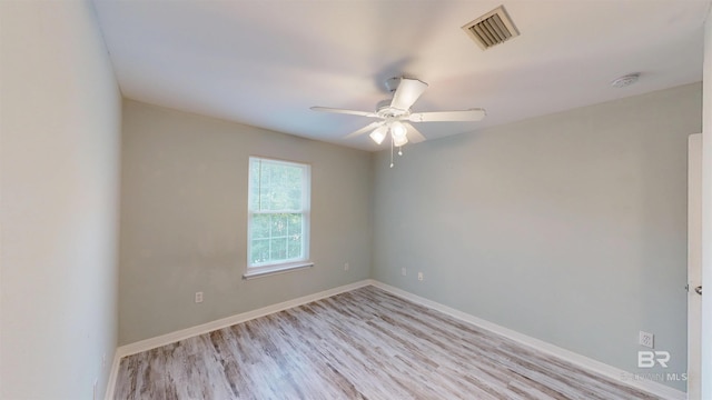 spare room with a ceiling fan, baseboards, visible vents, and light wood-type flooring