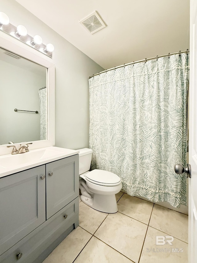 bathroom featuring toilet, visible vents, tile patterned flooring, and vanity