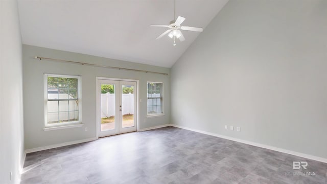 spare room featuring french doors, baseboards, ceiling fan, and high vaulted ceiling