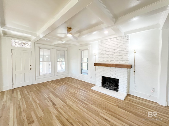 unfurnished living room with ceiling fan, a brick fireplace, wood finished floors, and coffered ceiling