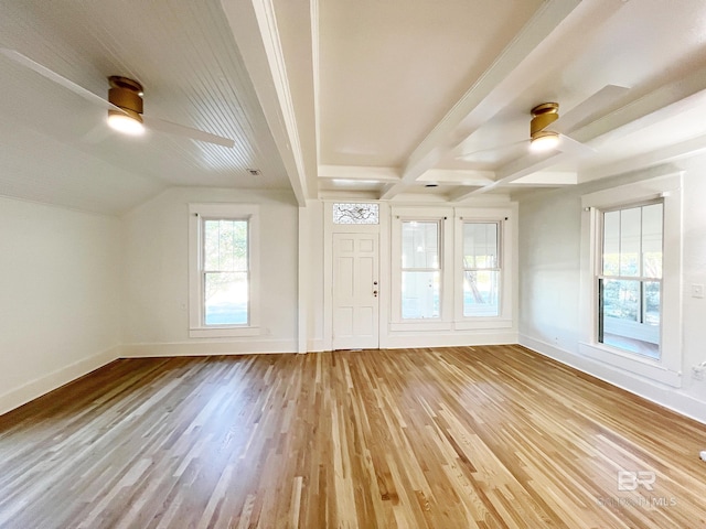 interior space featuring beamed ceiling, a ceiling fan, baseboards, and light wood-style floors